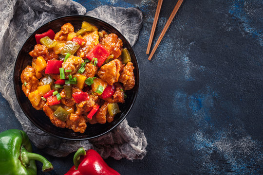 Sweet and sour chicken with colorful bell pepper on a plate