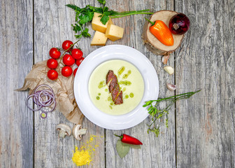  cheese soup on the table in a basket with vegetables and seasonings