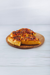 Homemade pizza on white wooden background on kitchen board