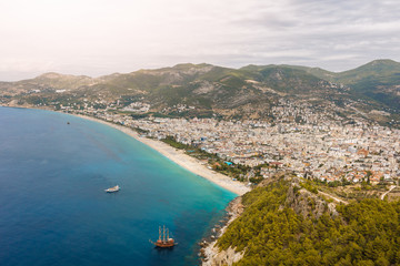 the coastline on the background of the city and mountains. Turkey, Alanya. Top view