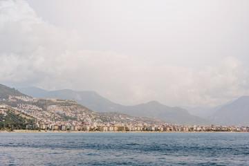 Fototapeta premium the coastline on the background of the city and mountains
