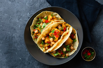 Flapjack aloo gobi chickpeas dark background top view
