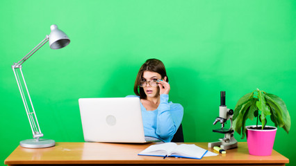 Inspired to work hard. digital science. businesswoman. chemist biologist with microscope on table....