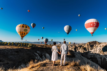 Wedding travel. Honeymoon trip. Couple in love among balloons. A guy proposes to a girl. Couple in...