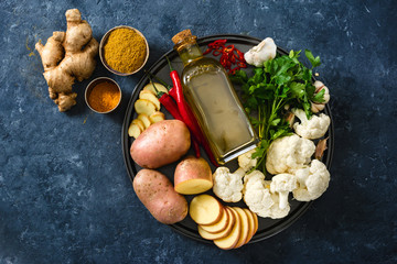 Raw ingredients cooking aloo gobi Indian food