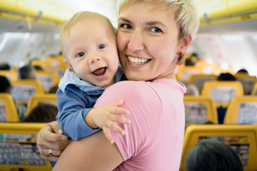 Mother with six months old baby boy in the airplane