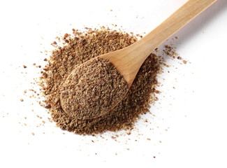 Ground, milled flaxseed, linseed with wooden spoon isolated on white background