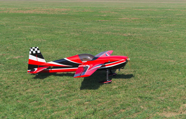 RC acrobatic model airplane on green grass