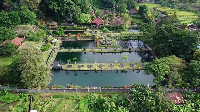 Aerial view of Tirta Ganga surrounded by rice fields and trees.