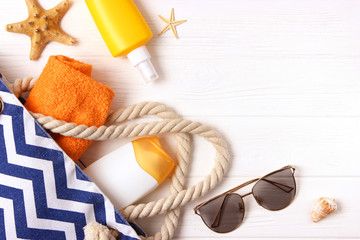  seashells, beach accessories and sun protection on a colored background top view. Sunscreen