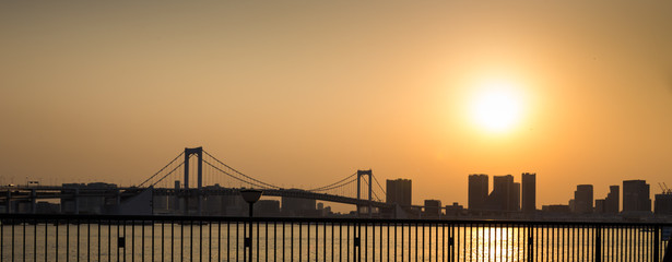 Odaiba, Tokyo, Japan, 04/06/2019 , Highway to the Rainbow Bridge, connecting Odaiba with Tokyo during sunset. View from Toyosu.