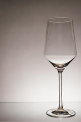 glass of white wine with wave on white background