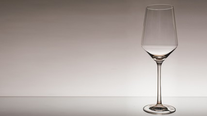 glass of white wine with wave on white background