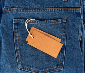 empty paper tag on a rope tied to blue jeans