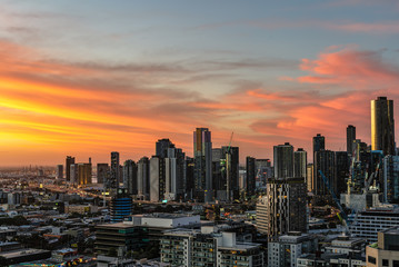 Melbourne skyline lit up at sunset