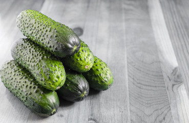 Fresh cucumbers on a black and white background copy space