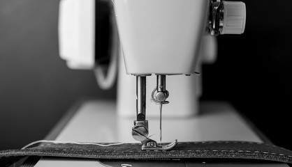 Background type of sewing machine, leather belt sewing process. Leather workshop.