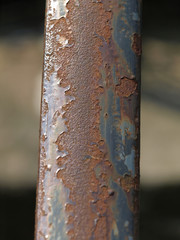 worn colour on a metallic railing
