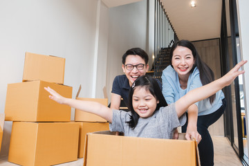Asian family moving to new home / apartment with many packing boxes