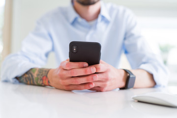 Close up of business man working using smartphone
