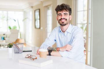 Young business man working with a happy and cool smile on face. Lucky person.