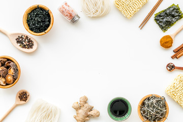 Rice vermicelli, noodles, spices, weeds frame to cook Chinese and Japanese food on white background top view copy space