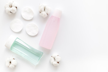 skin care cosmetics with facial tonic, mycelial water and cotton pads on white background top view mockup