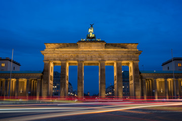 Traffic's light trails in front of the famous and illuminated Brandenburg Gate (Brandenburger Tor) in Berlin, Germany, in the evening. © tuomaslehtinen