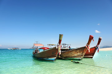 Naklejka na ściany i meble Longtale boat on the white beach at Phuket, Thailand. Phuket is a popular destination famous for its beaches.