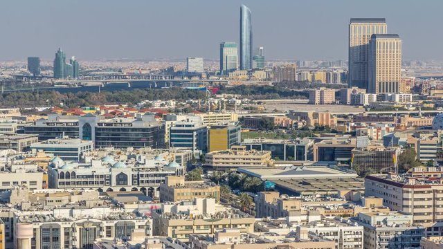 Aerial view of neighbourhood Deira and Dubai creek with typical old and modern buildings timelapse. Festival city on background. View from skyscraper rooftop. Dubai, United Arab Emirates