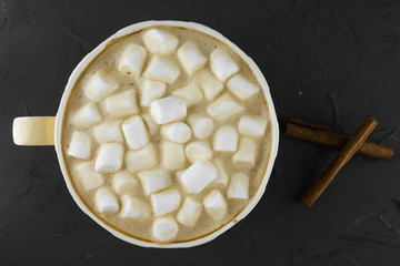 Nice Cup of coffee with marshmallow. Dark background. Flat lay.