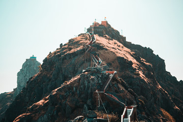 View of the Gorkhnath temple as seen from Ambaji Temple at the top of Mount Girnar in Junagadh, Gujarat, India
