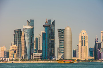 Fototapeta na wymiar Panoramic view of the skyscrapers from the Persian Gulf. Futuristic skyline in the financial district of Qatar
