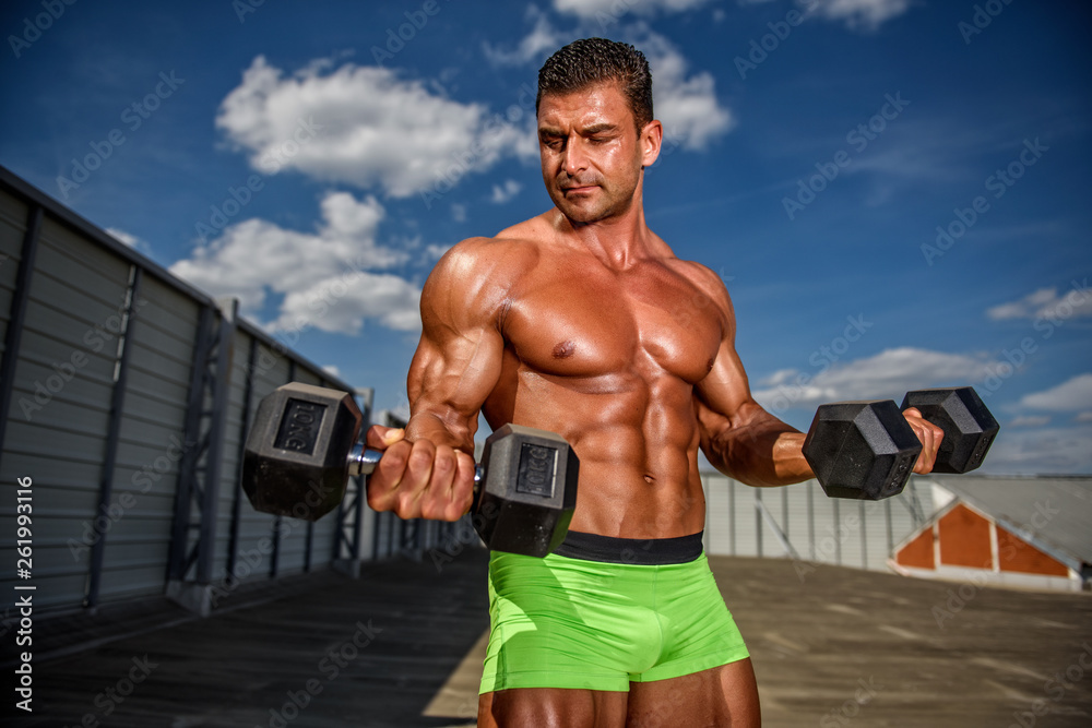 Wall mural bodybuilder exercise with weights outdoors