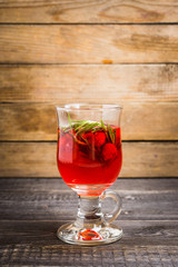 Hot raspberry beverage with rosemary. Selective focus. Shallow depth of field.