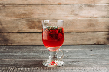 Hot raspberry beverage with rosemary. Selective focus. Shallow depth of field.
