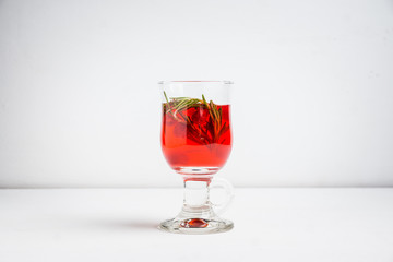 Hot raspberry beverage with rosemary. Selective focus. Shallow depth of field.