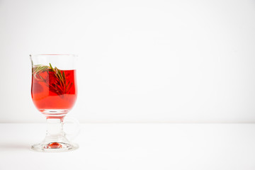 Hot raspberry beverage with rosemary. Selective focus. Shallow depth of field.