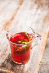 Hot raspberry beverage with rosemary. Selective focus. Shallow depth of field.