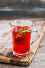 Hot raspberry beverage with rosemary. Selective focus. Shallow depth of field.