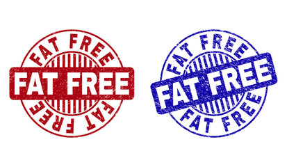 Grunge FAT FREE round stamp seals isolated on a white background. Round seals with grunge texture in red and blue colors. Vector rubber watermark of FAT FREE label inside circle form with stripes.