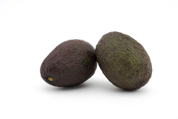 Two avocados or alligator pears on white background. Avocado has many nutrients.