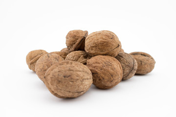 Walnuts on white background. The health benefits of walnuts are many.