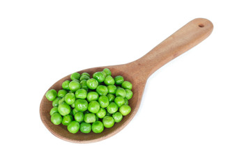 green peas on wooden spoon on white background.
