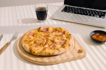 Tasty pizza on working table at office.
