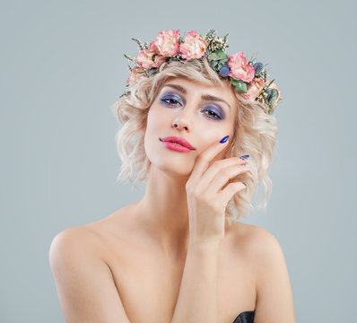 Pretty woman with blonde hair, makeup and flowers crown