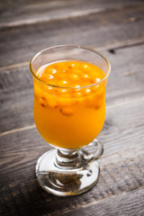 Hot buckthorn beverage in glass. Selective focus. Shallow depth of field. 