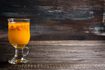 Hot buckthorn beverage in glass. Selective focus. Shallow depth of field. 