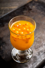 Hot buckthorn beverage in glass. Selective focus. Shallow depth of field. 