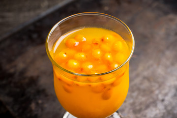 Hot buckthorn beverage in glass. Selective focus. Shallow depth of field. 